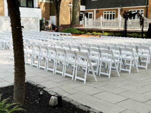 White Resin Folding Chairs being prepared for a wedding in Princeton, NJ.